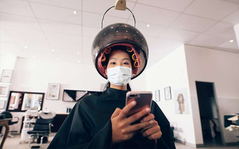 Female getting her hair steaming and moisturizing treatment in hair salon
