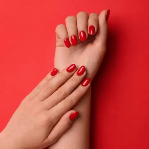 Woman,With,Gel,Polish,On,Nails,Against,Red,Background,,Top Woman,With,Gel,Polish,On,Nails,Against,Red,Background,,Top